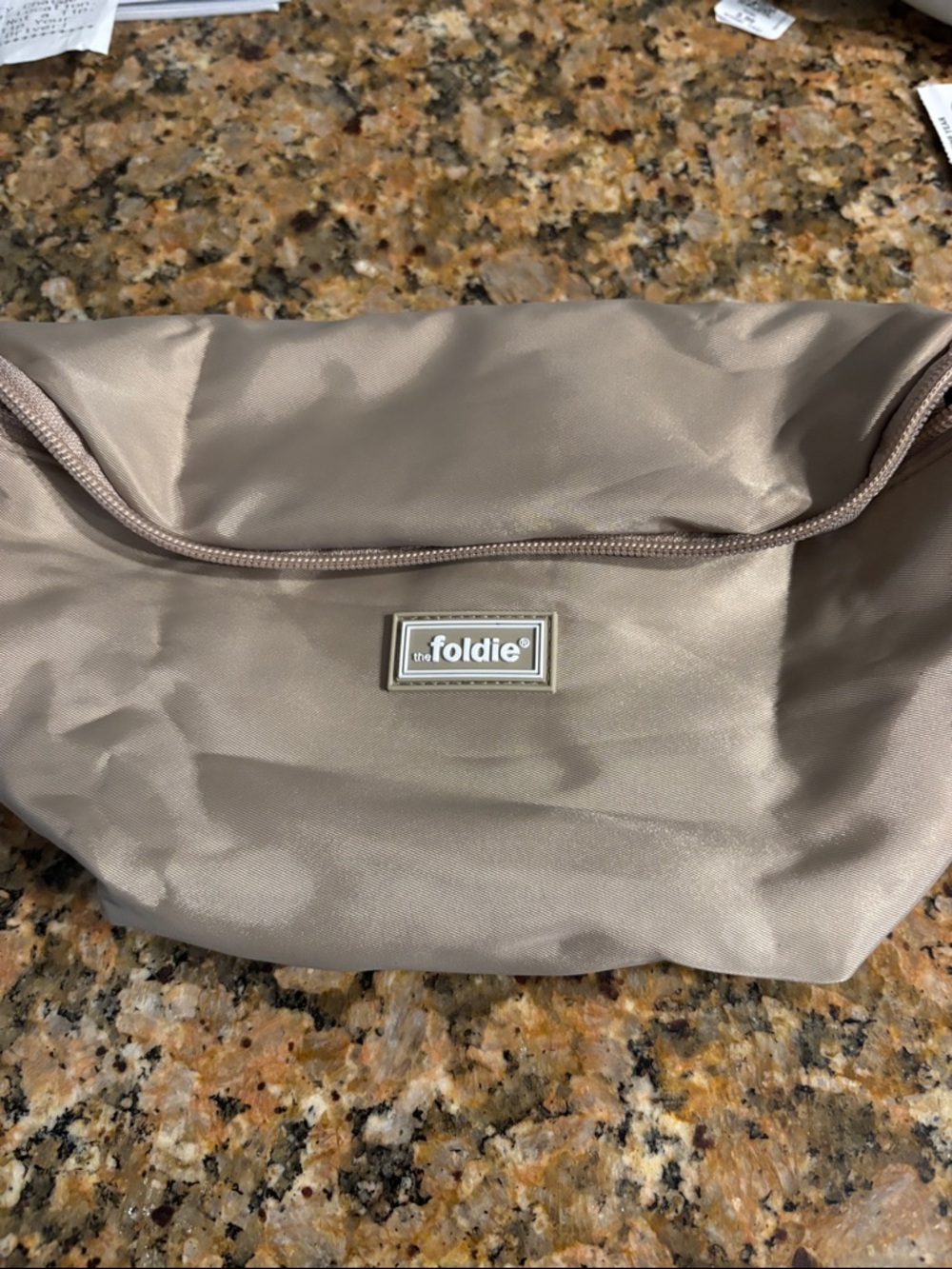 The Foldie Taupe Crossbody Pouch with Logo Plaque